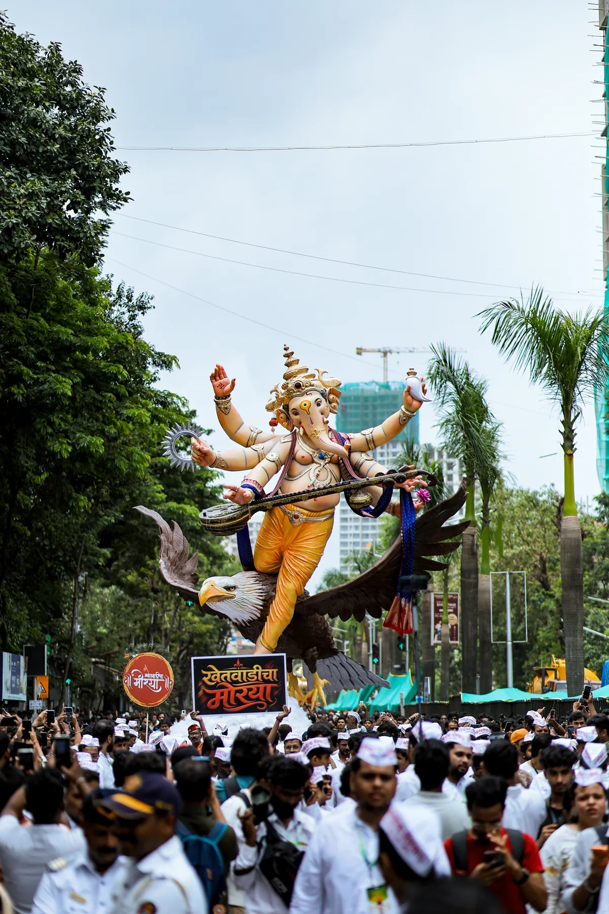 The murti above a sea of white caps on the street